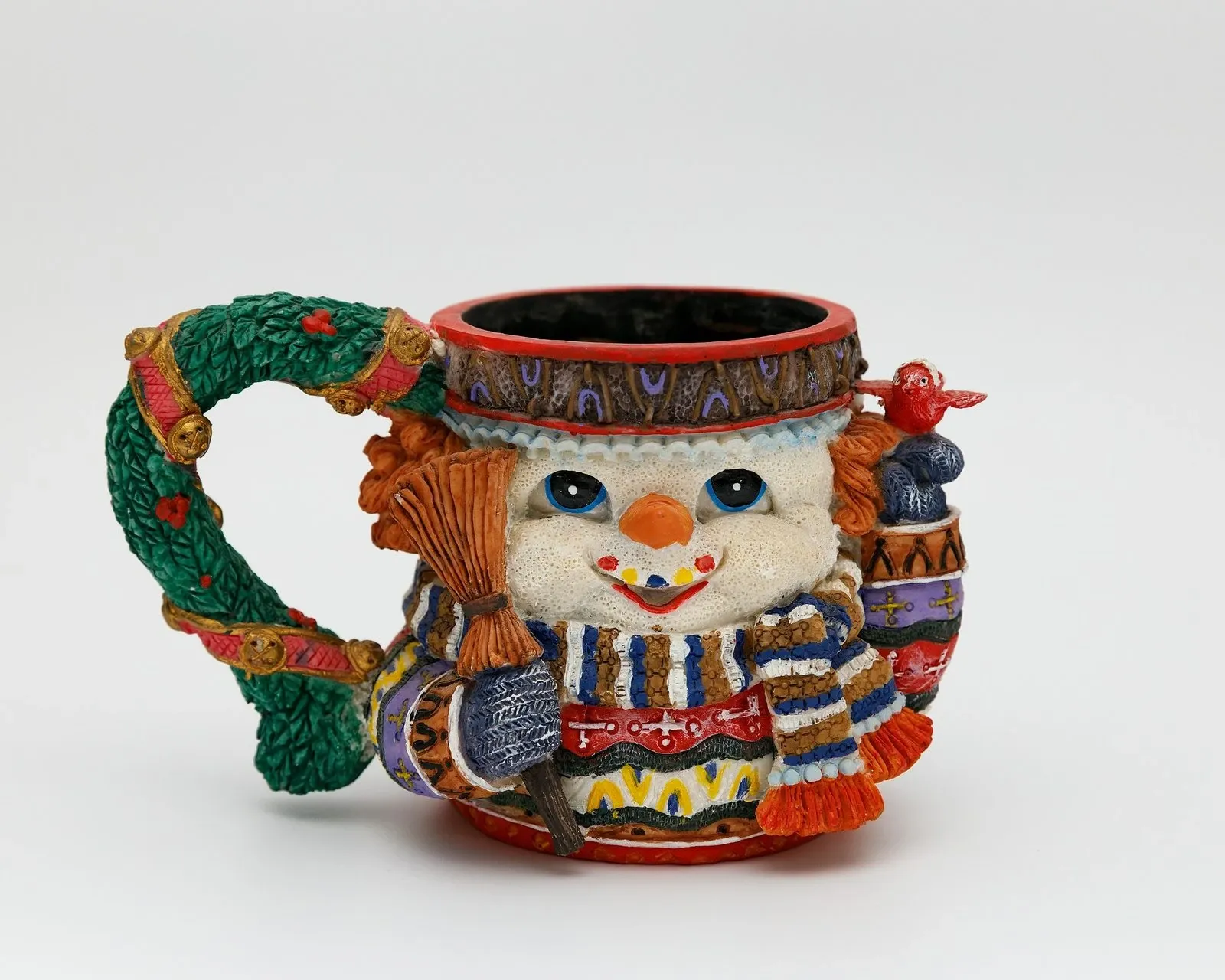 Hand-painted snowman mug with a colorful knit scarf and hat sculpted around the cup